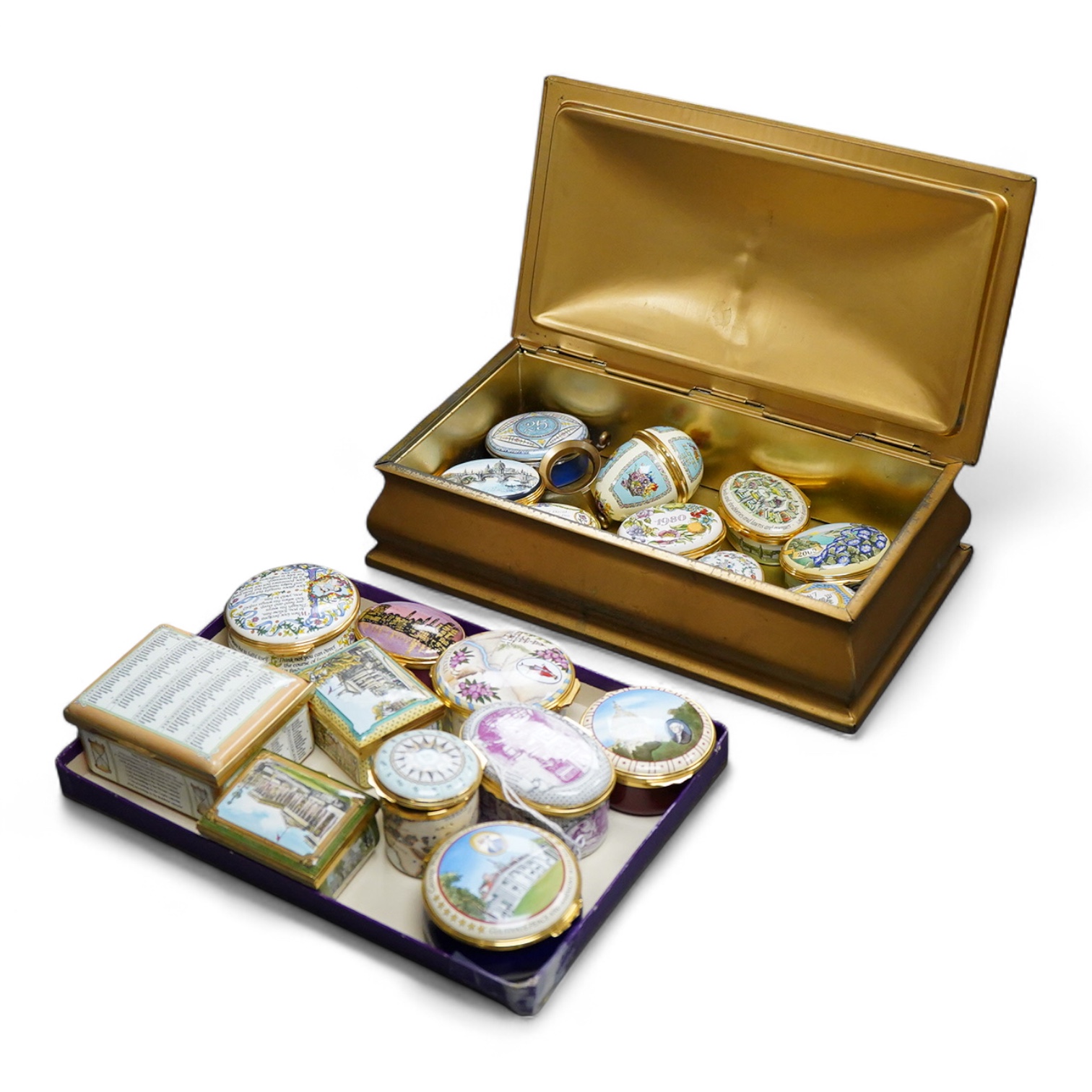 Eighteen Halcyon days enamel boxes and an enamel egg shaped box on stand